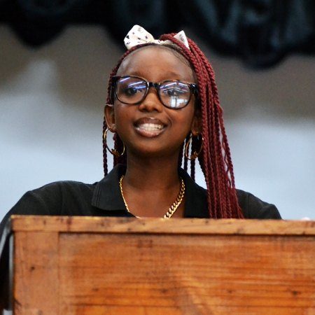 A learner speaking at a podium